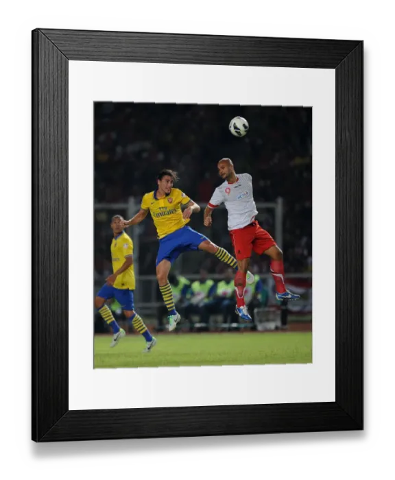 Framed Print : Clash of Stars: Ignasi Miquel vs. Sergio Van Duk (Arsenal vs. Indonesia All-Stars, 2013)