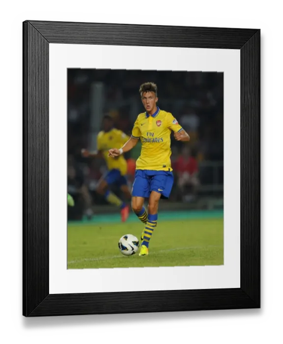 Framed Print : Arsenal's Kris Olsson in Action against Indonesia Dream Team (2013-14)