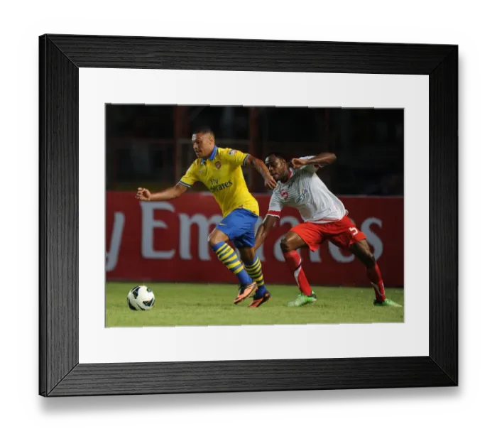 Framed Print : Arsenal's Alex Oxlade-Chamberlain Faces Off Against Victor Igbonefo of Indonesia Dream Team Framed Print : Arsenal's Alex Oxlade-Chamberlain Faces Off Against Victor Igbonefo of Indonesia Dream Team