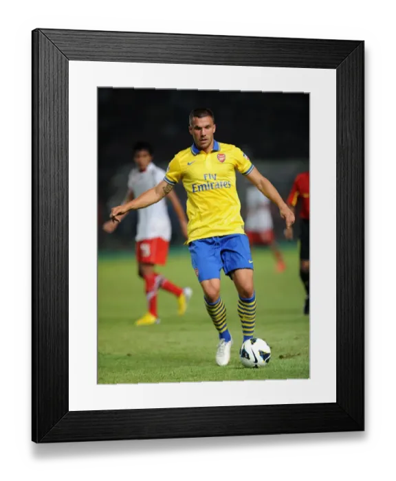 Framed Print : Lukas Podolski: Arsenal Star Shines in Indonesia All-Stars Match, 2013