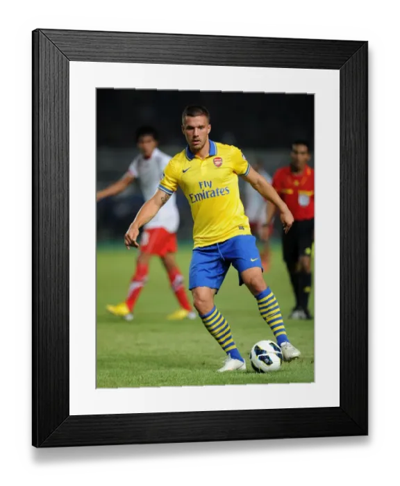 Framed Print : Lukas Podolski's Brilliant Performance: Arsenal's Victory against Indonesia All-Stars, July 2013