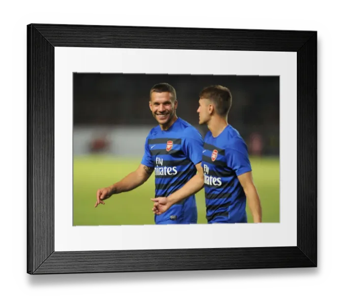 Framed Print : Arsenal Stars: Lukas Podolski and Aaron Ramsey Pre-Match Chat with Indonesia All-Stars (2013)