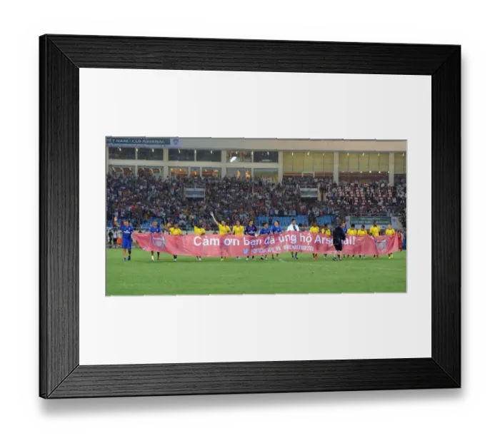 Framed Print : Arsenal Players Honor Vietnamese Fans with Banner at Vietnam Friendly Match, 2013