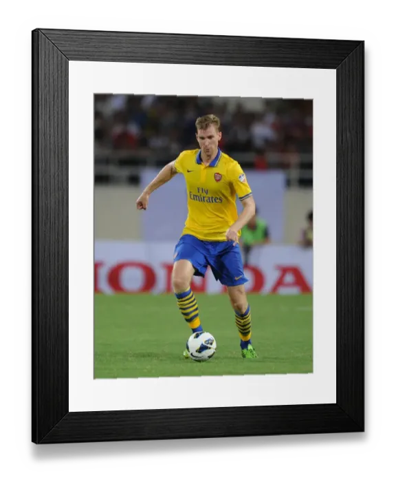 Framed Print : Per Mertesacker in Action: Vietnam vs. Arsenal (2013)