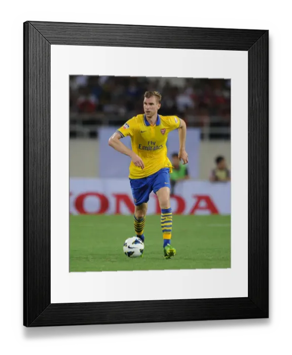 Framed Print : Per Mertesacker in Action: Vietnam vs. Arsenal (2013)