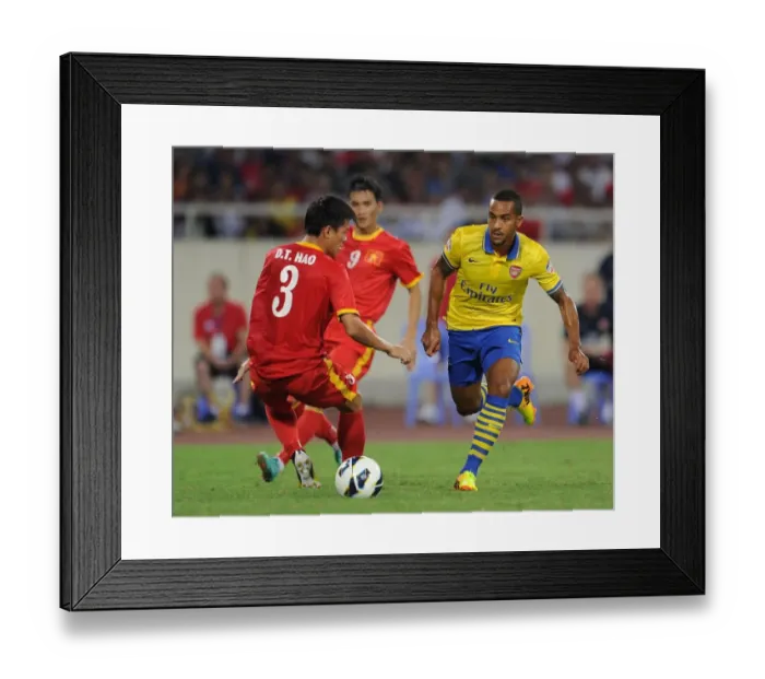 Framed Print : Theo Walcott Outruns Duong Thanh Hao: Vietnam vs Arsenal Friendly, 2013 Framed Print : Theo Walcott Outruns Duong Thanh Hao: Vietnam vs Arsenal Friendly, 2013