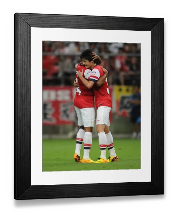Framed Print : Arsenal's Miyaichi and Walcott Celebrate Goal in Nagoya Grampus Match, 2013