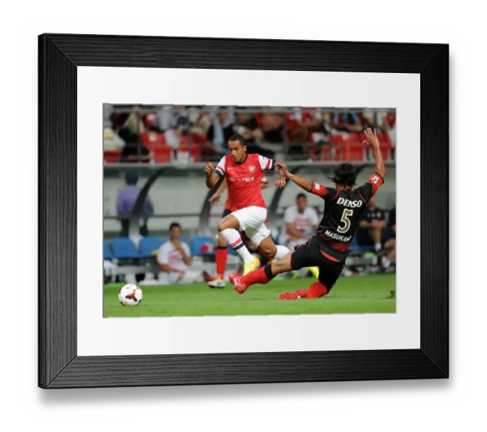 Framed Print : Theo Walcott Outmaneuvers Takahiro Masukawa: Nagoya Grampus vs. Arsenal, 2013