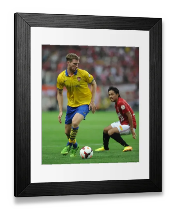 Framed Print : Per Mertesacker Faces Off Against Shinzo Koroki in Urawa Red Diamonds vs. Arsenal Clash