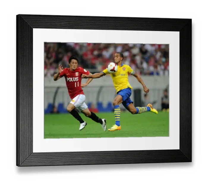 Framed Print : Theo Walcott vs. Kunimitsu Sekiguchi: A Battle for Ball Possession in Arsenal's 2013 Pre-Season Clash with Urawa Red Diamonds