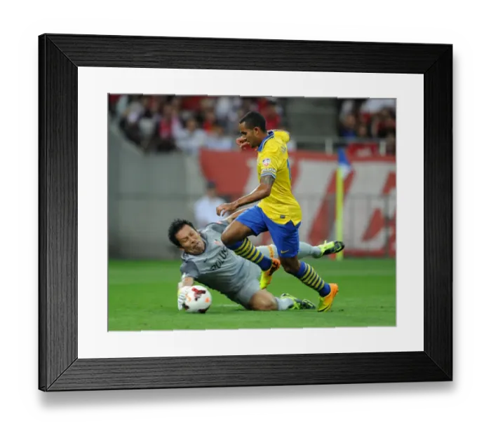 Framed Print : Theo Walcott vs. Norihiro Yamagishi: A Clash in the 2013-14 Urawa Red Diamonds vs. Arsenal Match