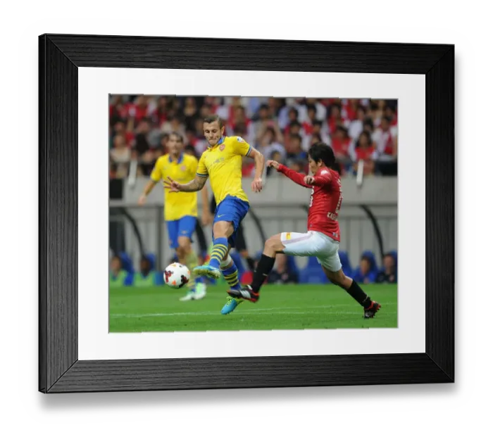 Framed Print : Jack Wilshere vs. Yosuke Kashiwagi: Clash of Midfielders in Urawa Red Diamonds vs. Arsenal (2013)