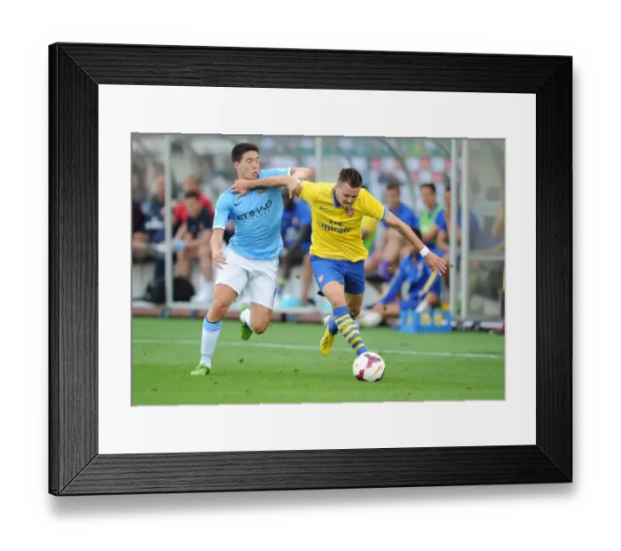 Framed Print : Arsenal's Carl Jenkinson Fends Off Manchester City's Samir Nasri in Pre-Season Clash