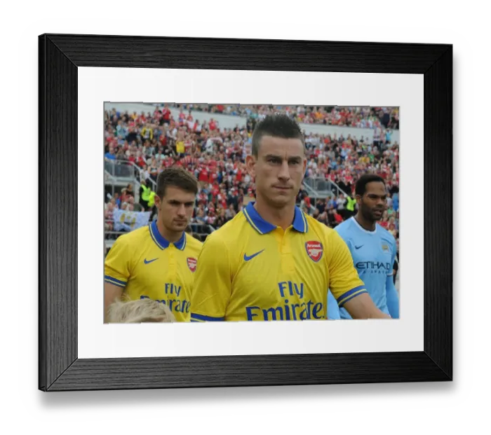 Framed Print : Laurent Koscielny: Arsenal's Focused Defender Ahead of Arsenal vs Manchester City Pre-Season Clash (2013)