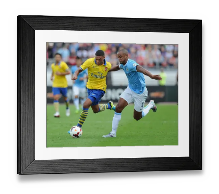 Framed Print : Arsenal's Alex Oxlade-Chamberlain Outmaneuvers Manchester City's Vincent Kompany Framed Print : Arsenal's Alex Oxlade-Chamberlain Outmaneuvers Manchester City's Vincent Kompany