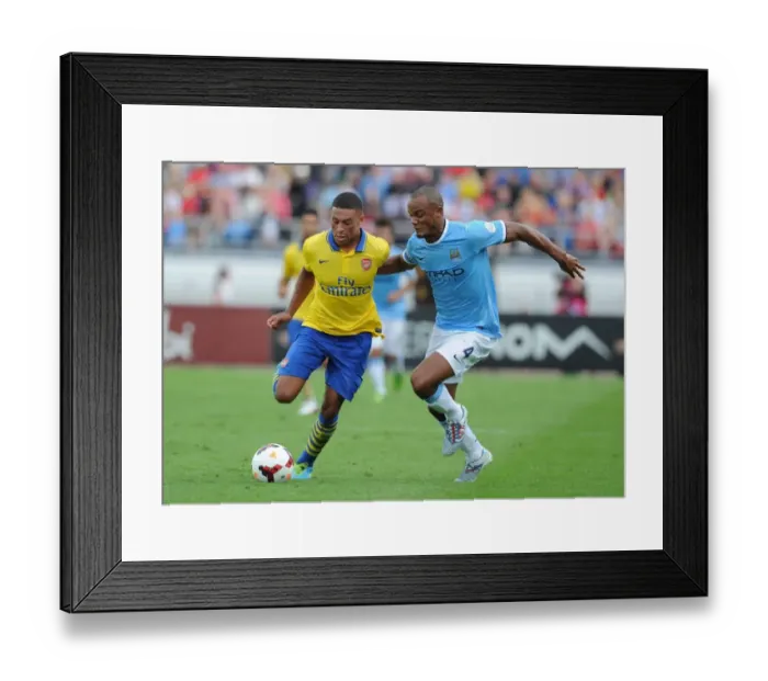 Framed Print : Alex Oxlade-Chamberlain Outwits Vincent Kompany: Arsenal's Agile Midfielder Dazzles Manchester City's Defender Framed Print : Alex Oxlade-Chamberlain Outwits Vincent Kompany: Arsenal's Agile Midfielder Dazzles Manchester City's Defender