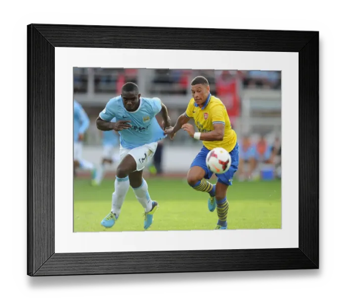 Framed Print : Arsenal's Alex Oxlade-Chamberlain Faces Off Against Micah Richards in Manchester City Pre-Season Clash