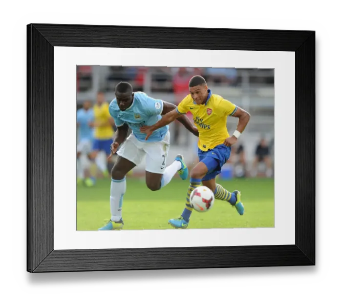 Framed Print : Arsenal's Alex Oxlade-Chamberlain Faces Off Against Manchester City's Micah Richards in Pre-Season Clash