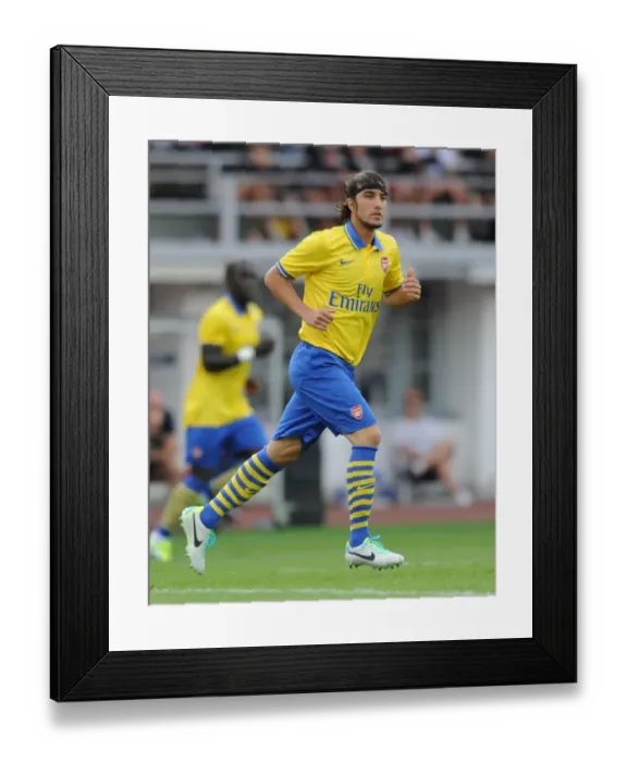 Framed Print : Arsenal's Sebastien Perez Goes Head-to-Head with Manchester City in 2013 Pre-Season Clash