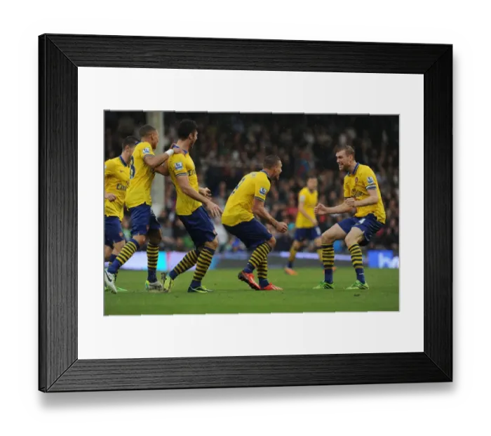 Framed Print : Podolski and Mertesacker Celebrate Arsenal's Winning Goals Against Fulham (2013-14)