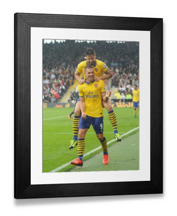 Framed Print : Euphoria Unleashed: Podolski and Giroud's Unforgettable Moment as Arsenal Scores the Third Goal Against Fulham (2013-14)