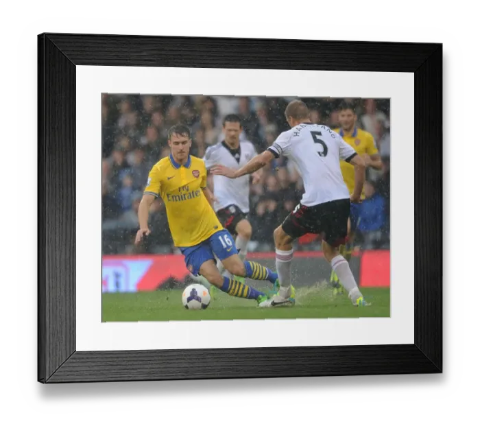 Framed Print : Arsenal's Aaron Ramsey Outmaneuvers Fulham's Brede Hangeland in Premier League Clash