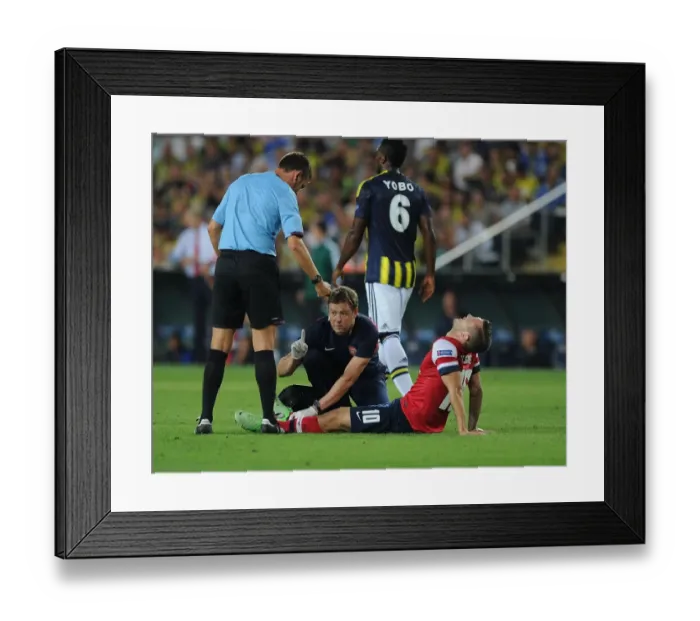 Framed Print : Arsenal's Colin Lewin Tends to Jack Wilshere's Injury in Fenerbahce Showdown Framed Print : Arsenal's Colin Lewin Tends to Jack Wilshere's Injury in Fenerbahce Showdown