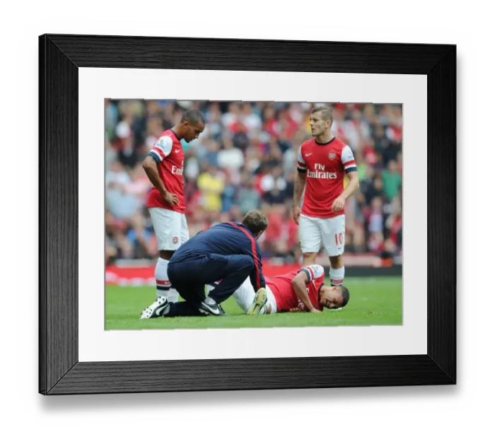 Framed Print : Arsenal: Oxlade-Chamberlain Receives Treatment from Physio Colin Lewin during Arsenal v Aston Villa Match, 2013-14 Framed Print : Arsenal: Oxlade-Chamberlain Receives Treatment from Physio Colin Lewin during Arsenal v Aston Villa Match, 2013-14