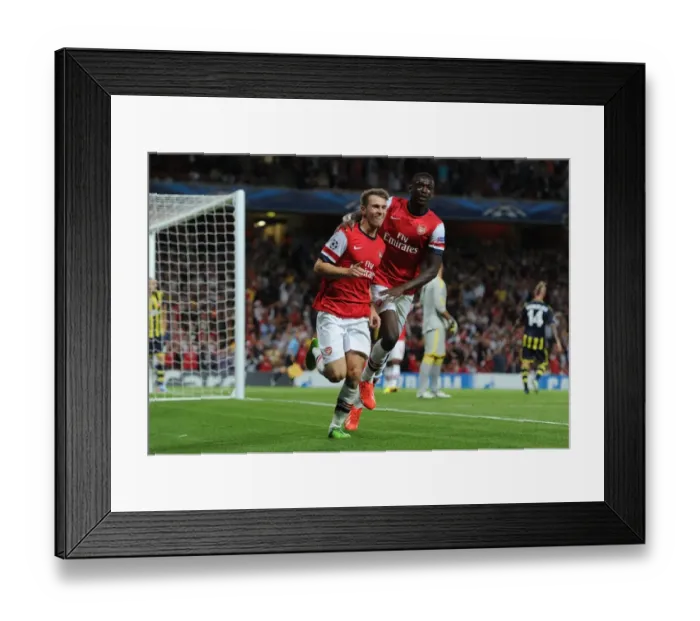 Framed Print : Arsenal's Aaron Ramsey and Yaya Sanogo Celebrate Goals in UEFA Champions League Play-offs Against Fenerbahce (2013)