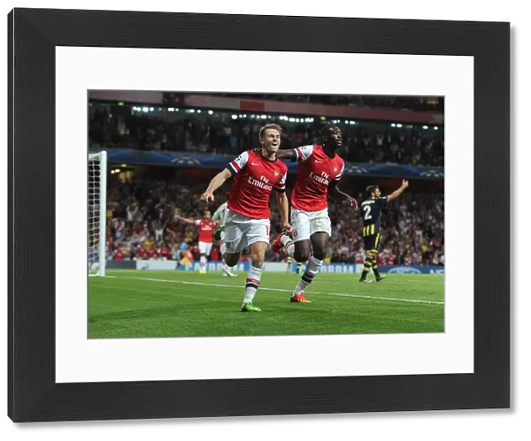 Arsenal Double Strike: Ramsey and Sanogo Celebrate Champions League Goals (2013-14)