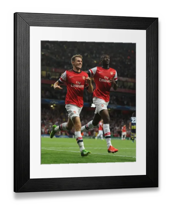 Framed Print : Arsenal's Ramsey and Sanogo: Celebrating Goals in UEFA Champions League Play-offs Against Fenerbahce (2013-14)