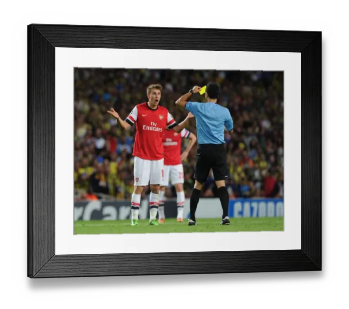 Framed Print : Arsenal's Aaron Ramsey Booked by Referee Velasco Carballo in Champions League Clash vs Fenerbahce Framed Print : Arsenal's Aaron Ramsey Booked by Referee Velasco Carballo in Champions League Clash vs Fenerbahce