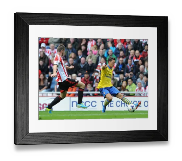 Framed Print : Mesut Ozil (Arsenal) passes for Arsenals 1st goal under pressure from Valentin Roberge