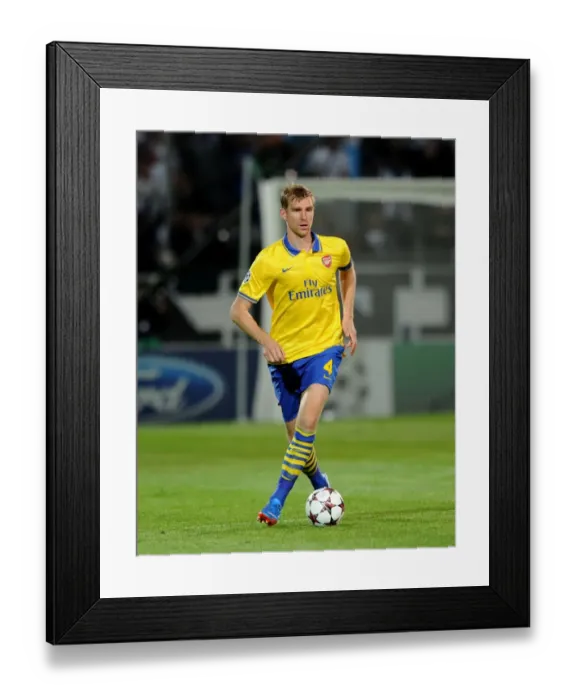 Framed Print : Per Mertesacker Focuses in Marseille's Champions League Clash against Arsenal