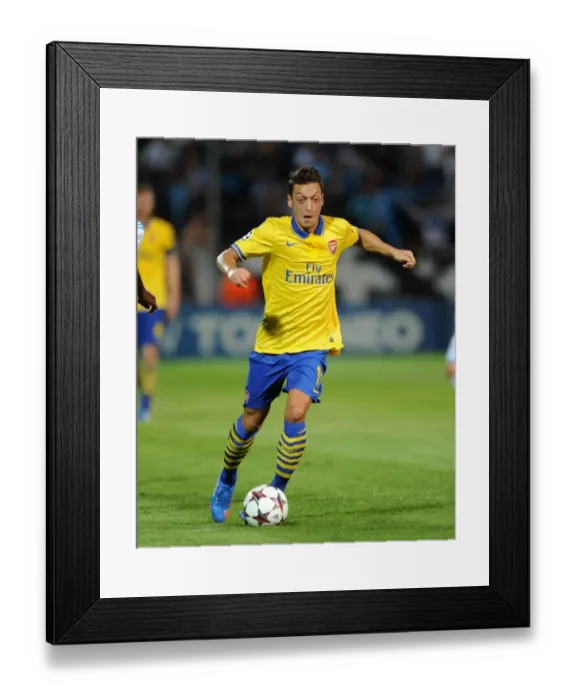 Framed Print : Mesut Ozil: Arsenal Star in Action against Olympique Marseille (2013-14 UEFA Champions League)