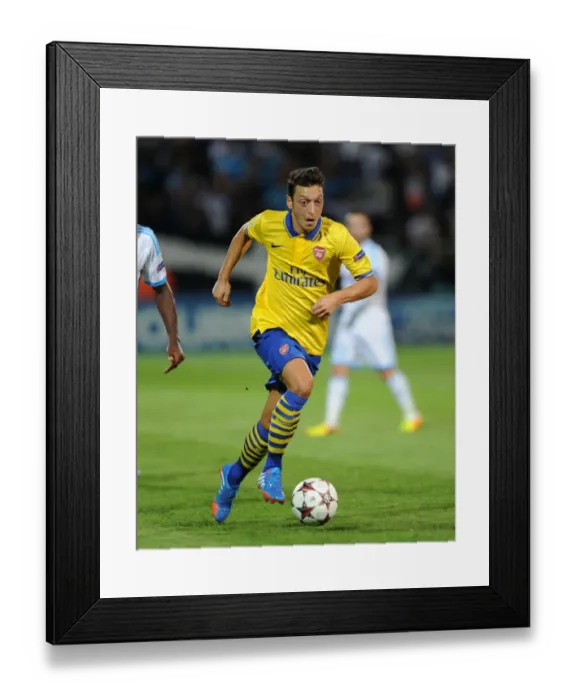 Framed Print : Mesut Ozil: Arsenal Star in Action against Olympique Marseille (2013-14)