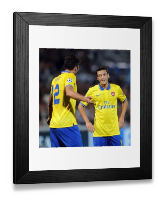 Framed Print : Mesut Ozil and Olivier Giroud: Arsenal's Dynamic Duo in Action against Olympique de Marseille, UEFA Champions League, 2013