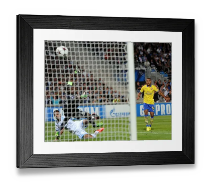 Framed Print : Theo Walcott's Champion Goal: Arsenal Triumphs over Marseille Framed Print : Theo Walcott's Champion Goal: Arsenal Triumphs over Marseille