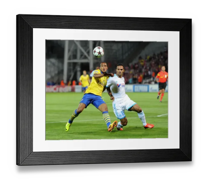 Framed Print : Theo Walcott vs. Jeremy Morel: A Champions League Showdown at Stade Velodrome Framed Print : Theo Walcott vs. Jeremy Morel: A Champions League Showdown at Stade Velodrome