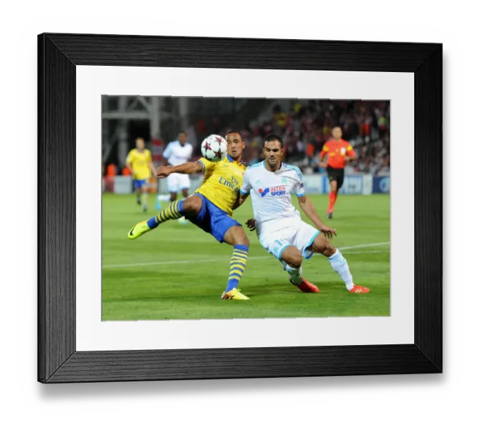 Framed Print : Theo Walcott vs. Jeremy Morel: A Tense Moment in the Marseille vs. Arsenal UEFA Champions League Clash
