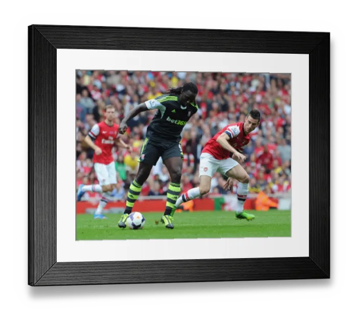 Framed Print : Laurent Koscielny (Arsenal) Kenwyne Jones (Stoke). Arsenal 3: 1 Stoke City. Barclays Premier League Framed Print : Laurent Koscielny (Arsenal) Kenwyne Jones (Stoke). Arsenal 3: 1 Stoke City. Barclays Premier League