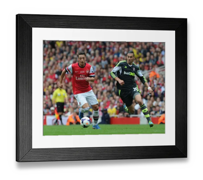 Framed Print : Mesut Ozil Outmaneuvers Geoff Cameron in Arsenal's Victory over Stoke City Framed Print : Mesut Ozil Outmaneuvers Geoff Cameron in Arsenal's Victory over Stoke City
