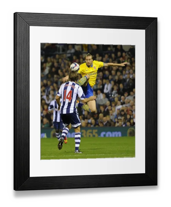 Framed Print : Bendtner vs. Laguno: Arsenal's Edge in the Capital One Cup Clash (West Bromwich Albion vs. Arsenal, 2013-14)