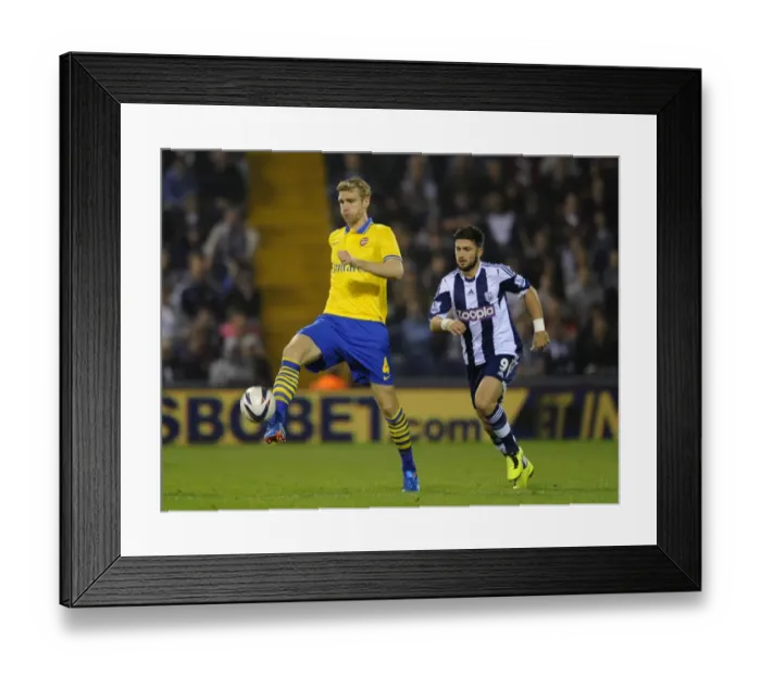 Framed Print : Per Mertesacker vs. Shane Long: A Battle for Control in the Capital One Cup (West Bromwich Albion vs. Arsenal, 2013-14)