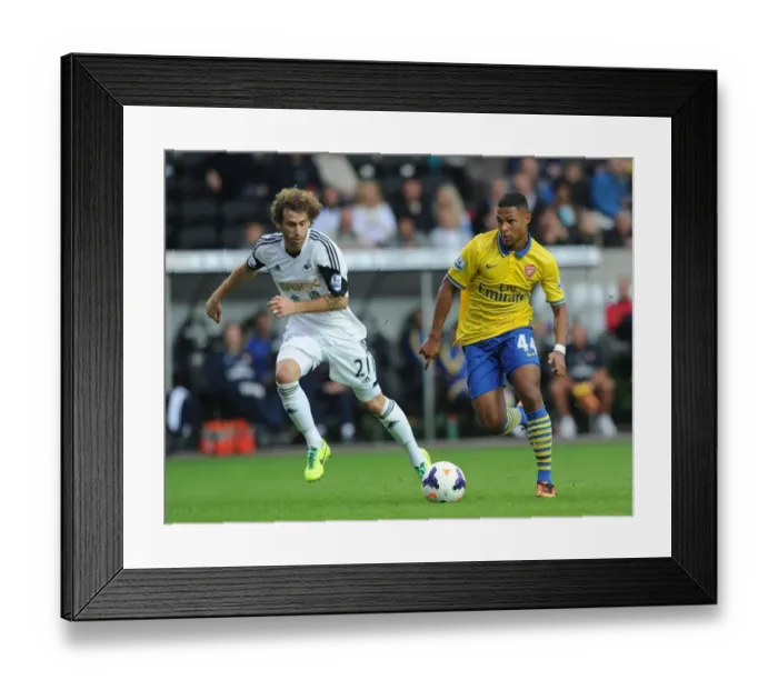 Framed Print : Serge Gnabry vs Jose Canas: Battle at Liberty Stadium - Swansea City vs Arsenal, Premier League 2013-14 Framed Print : Serge Gnabry vs Jose Canas: Battle at Liberty Stadium - Swansea City vs Arsenal, Premier League 2013-14