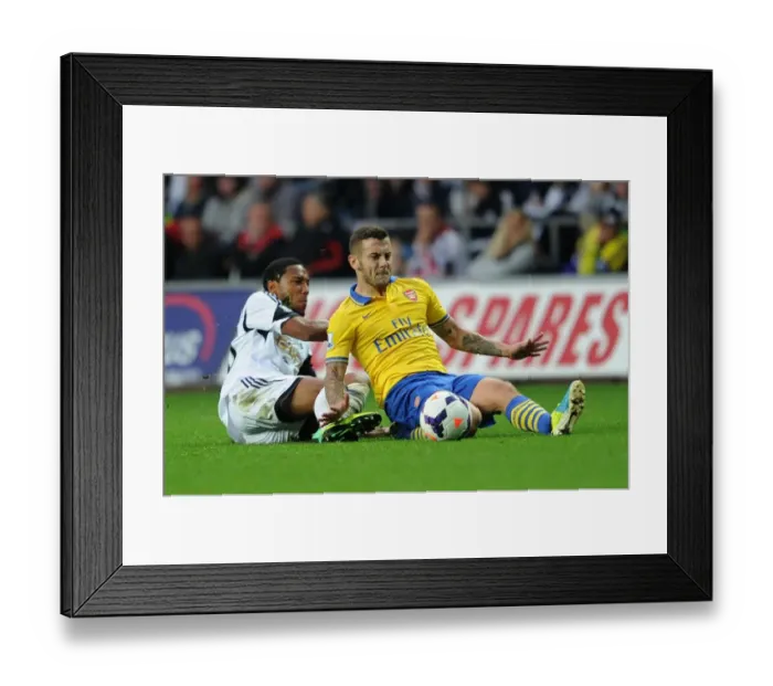 Framed Print : Jack Wilshere vs. Jonathan De Guzman: Intense Tackle in Swansea City vs. Arsenal Premier League Clash Framed Print : Jack Wilshere vs. Jonathan De Guzman: Intense Tackle in Swansea City vs. Arsenal Premier League Clash