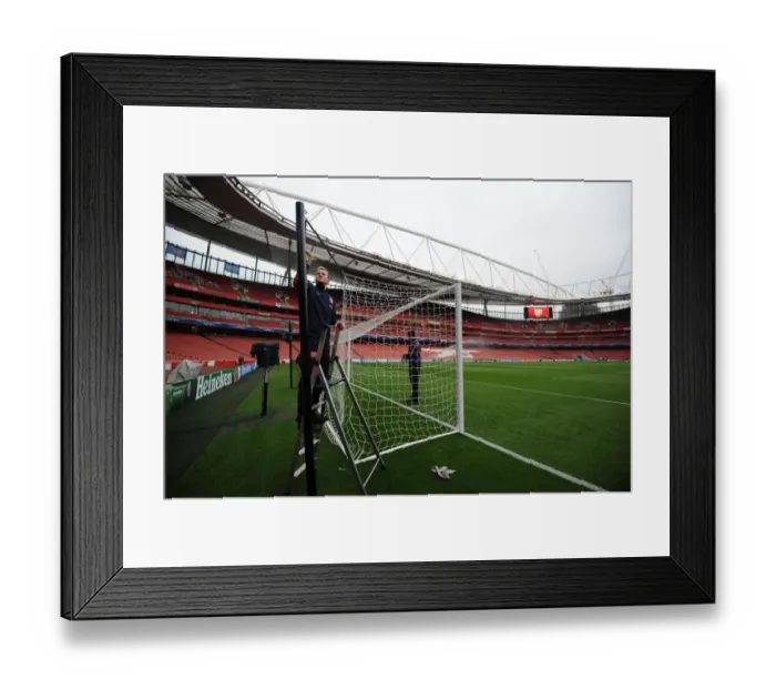 Framed Print : Preparing the North Bank: Arsenal Groundsmen Set Up for UEFA Champions League Clash (2013-14)