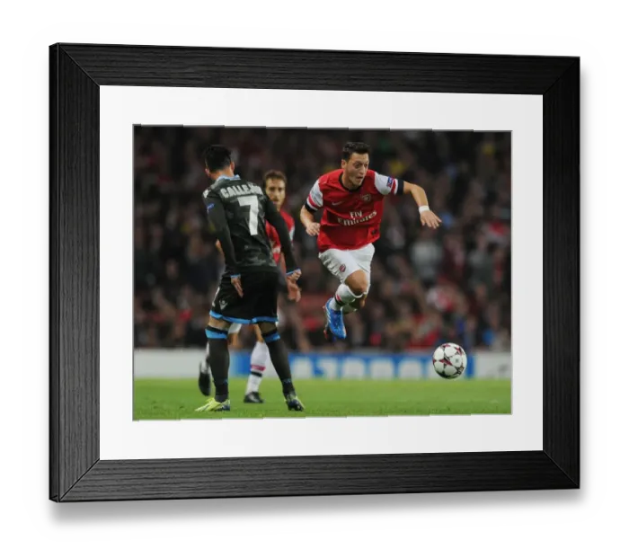 Framed Print : Mesut Ozil Outmaneuvers Jose Callejon in Arsenal's UEFA Champions League Clash