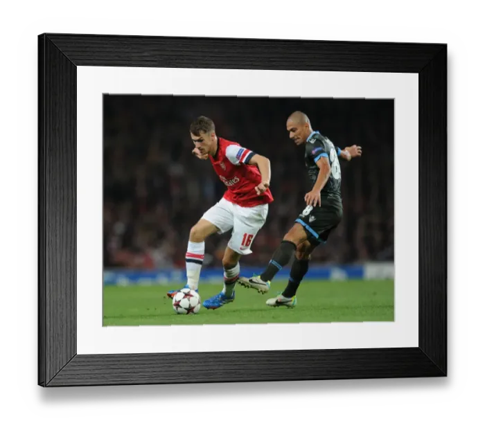 Framed Print : Arsenal's Aaron Ramsey Outwits Napoli's Gokhan Inler: A Moment of Genius in the Champions League Clash Framed Print : Arsenal's Aaron Ramsey Outwits Napoli's Gokhan Inler: A Moment of Genius in the Champions League Clash