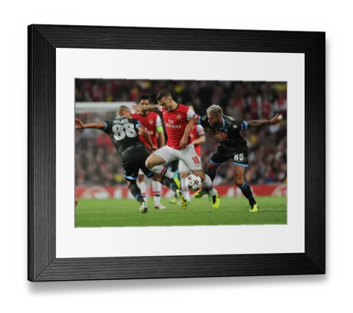 Framed Print : Arsenal's Wilshere Faces Off Against Inler and Behrami of Napoli in Champions League Clash